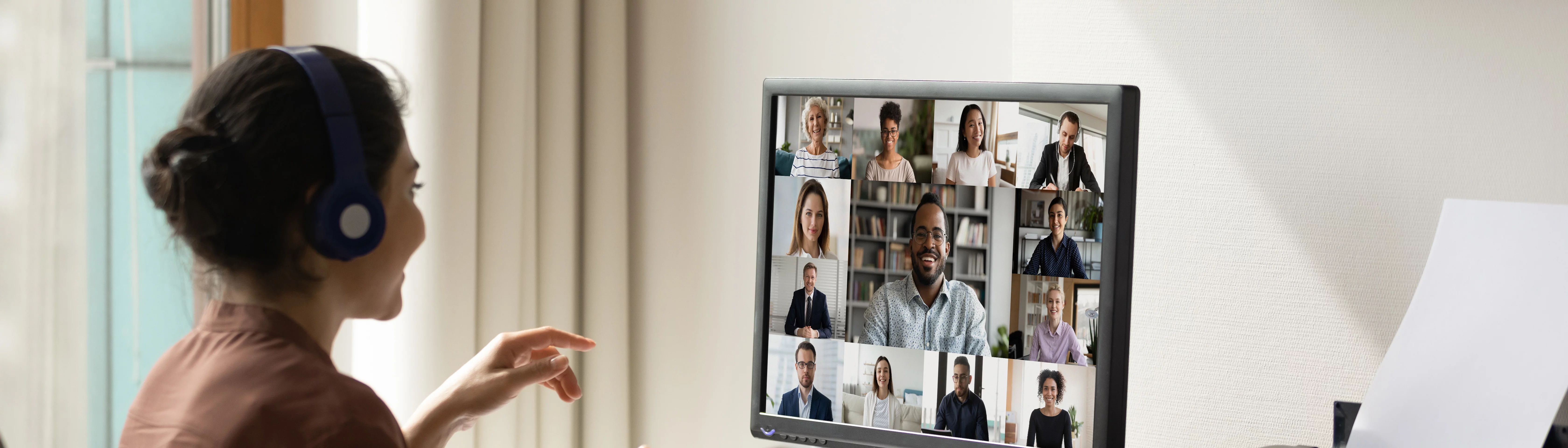 Woman smiling to people on her computer screen. Online meeting.